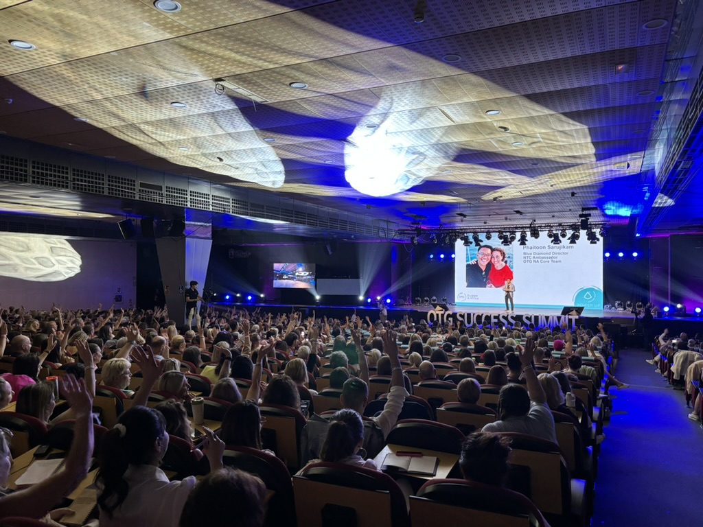 An international audience raising their hands during TOON’s business presentation