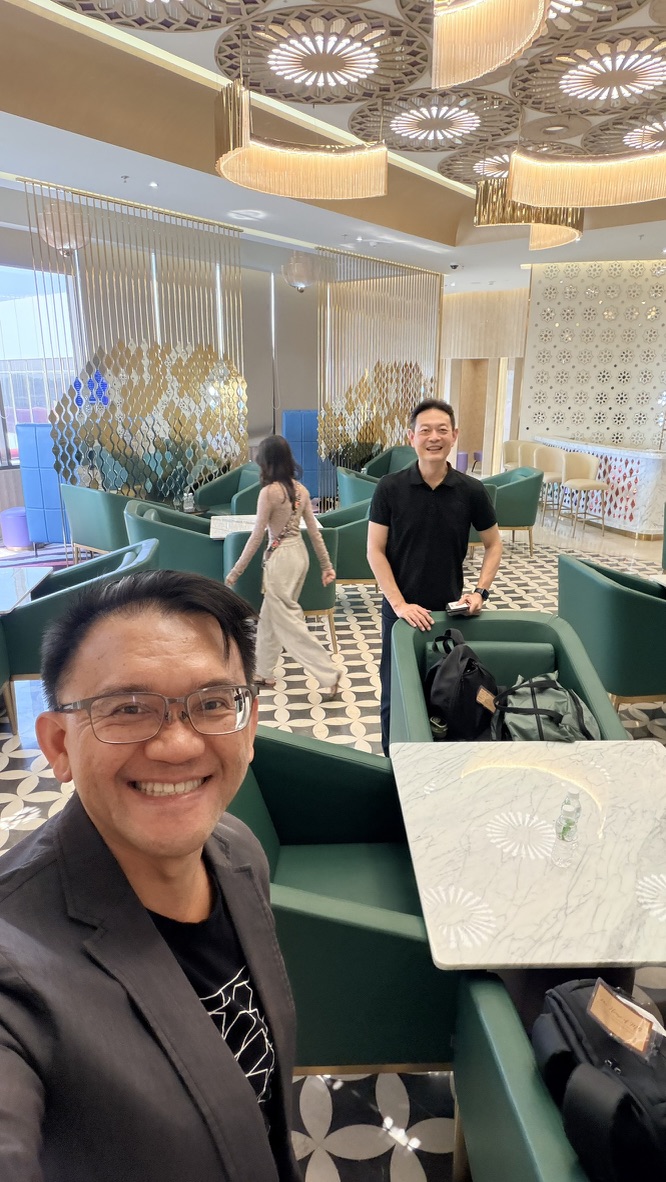 Two travellers seated in an airport lounge, India.