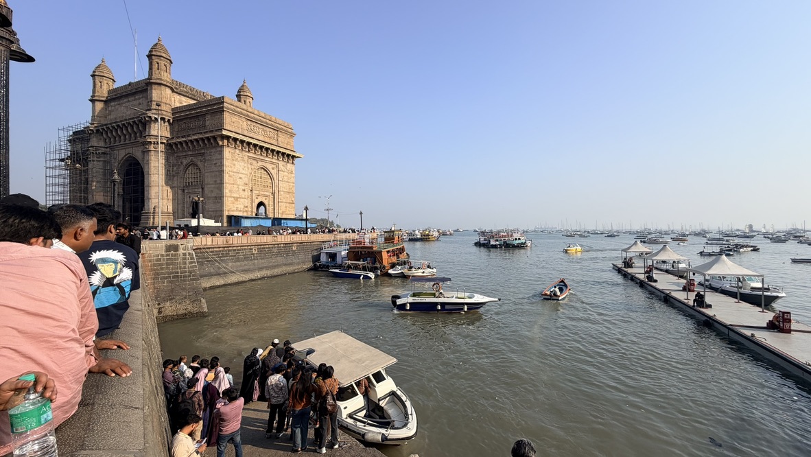 Gateway of India beside boats on Mumbai Harbour, Mumbai, India.