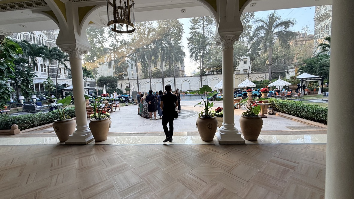 Pool courtyard seen through arches at the Taj Mahal Palace, Mumbai, India.
