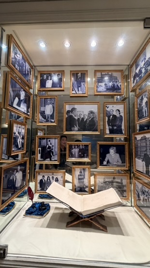 Historical photograph display inside the Taj Mahal Palace, Mumbai, India.