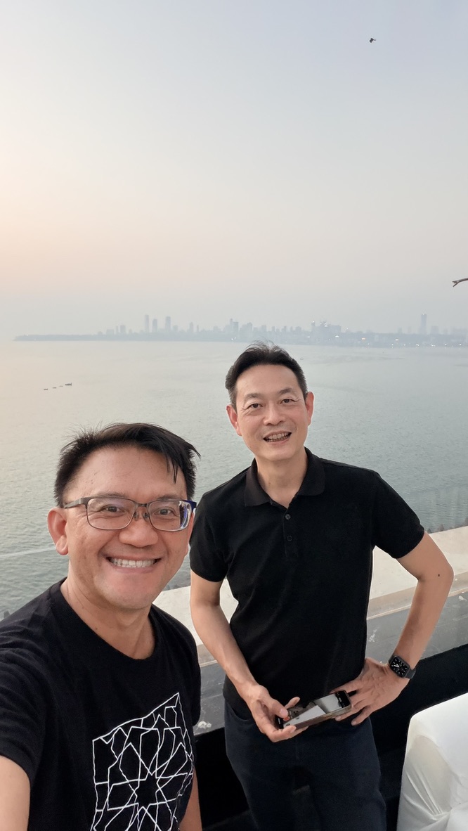 Two travellers above Back Bay at Dome rooftop bar, Mumbai, India.