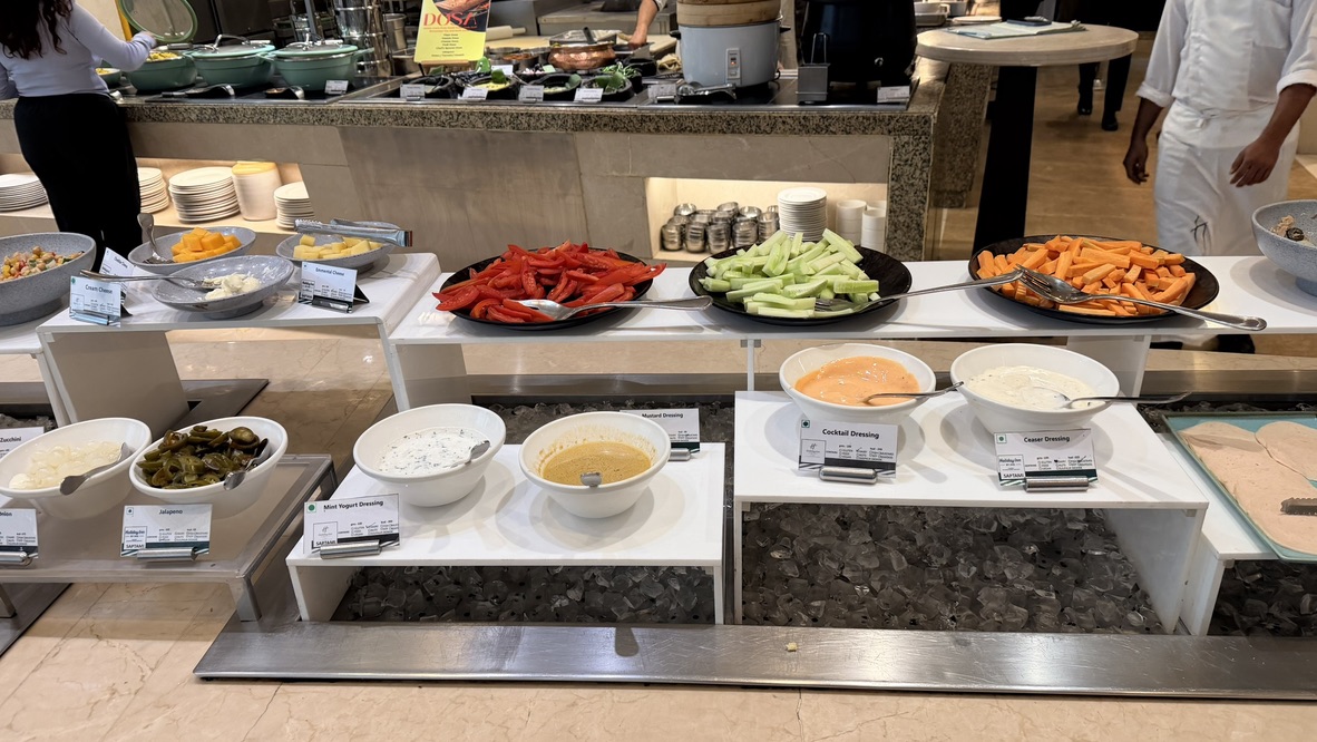 Salad vegetables and dressings on the Saptami restaurant buffet, Mumbai, India.