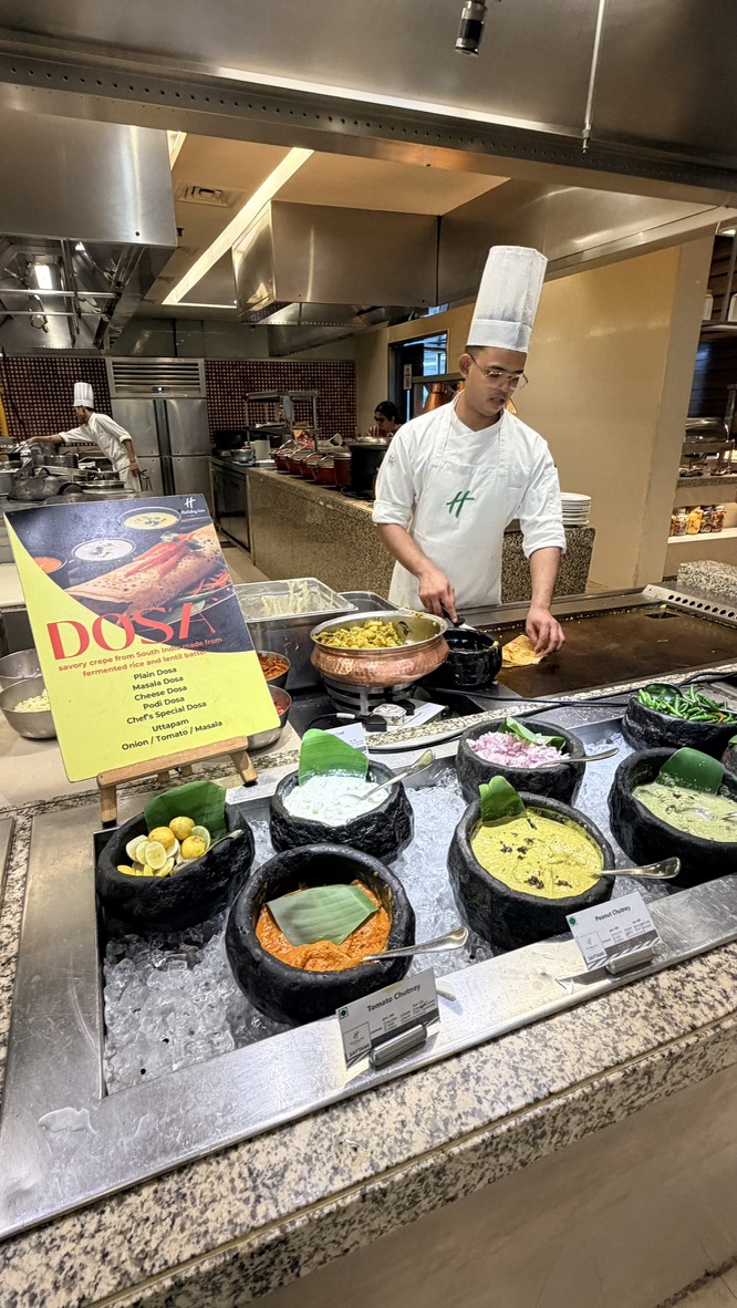 Chef preparing dosa at the Saptami restaurant live station, Mumbai, India.