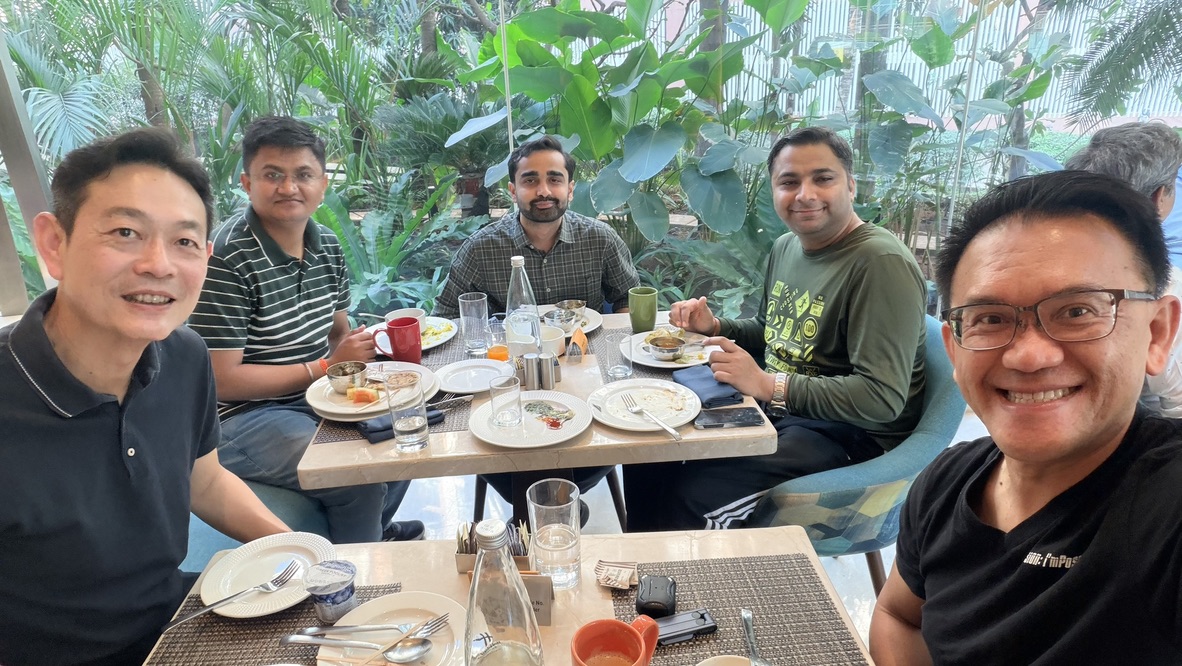Five colleagues meeting over breakfast at Holiday Inn Mumbai International Airport, India.