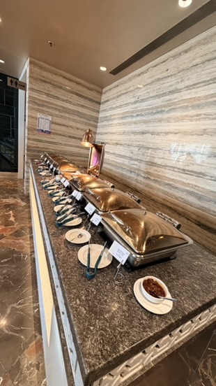 Hot buffet dishes inside an airport lounge in Mumbai, India.