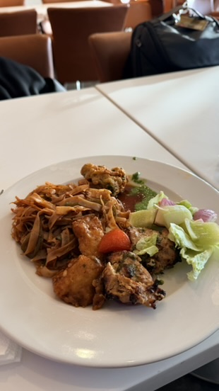 Plate of food prepared from the Mumbai airport lounge buffet.