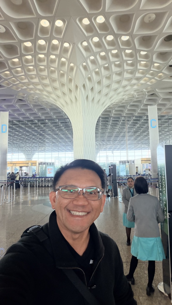 Traveller departing through the sculptural terminal at Mumbai airport, India.
