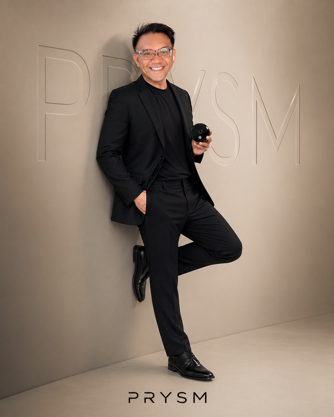 TOON holding the PRYSM iO scanner in a warm editorial portrait