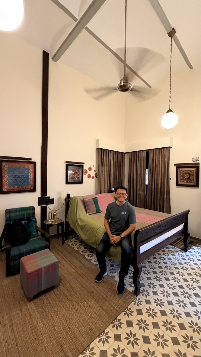 TOON seated in a high-ceilinged heritage guest room at The House of MG
