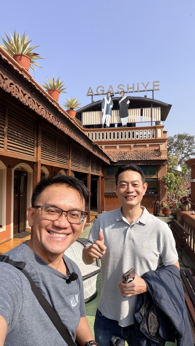 TOON and his travel companion on the terrace beneath the Agashiye sign at The House of MG