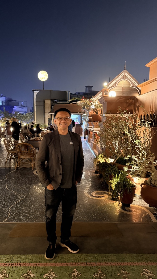 TOON standing on the illuminated Agashiye terrace at night