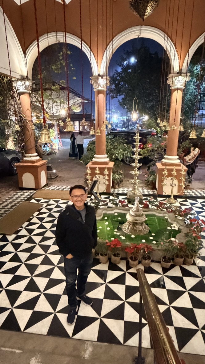 TOON standing in the arched entrance hall of The House of MG at night
