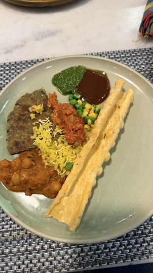 A breakfast plate with Indian dishes, chutneys, vegetables, and crisp breads at The House of MG