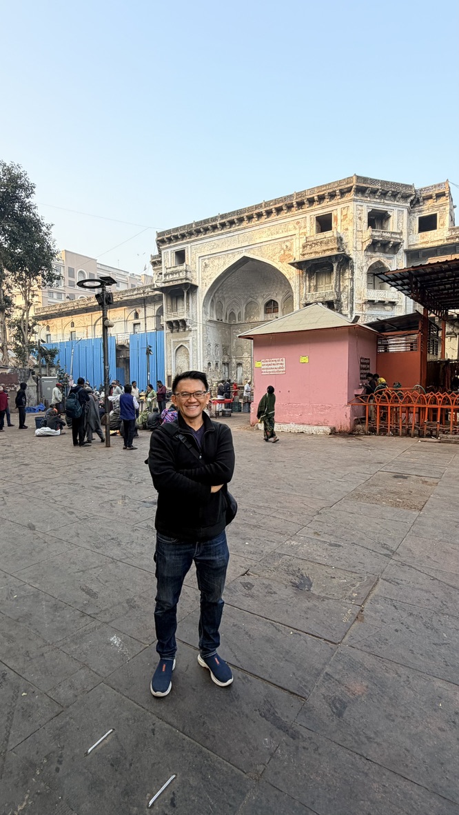 TOON standing before a monumental historic facade during a guided walk in old Ahmedabad