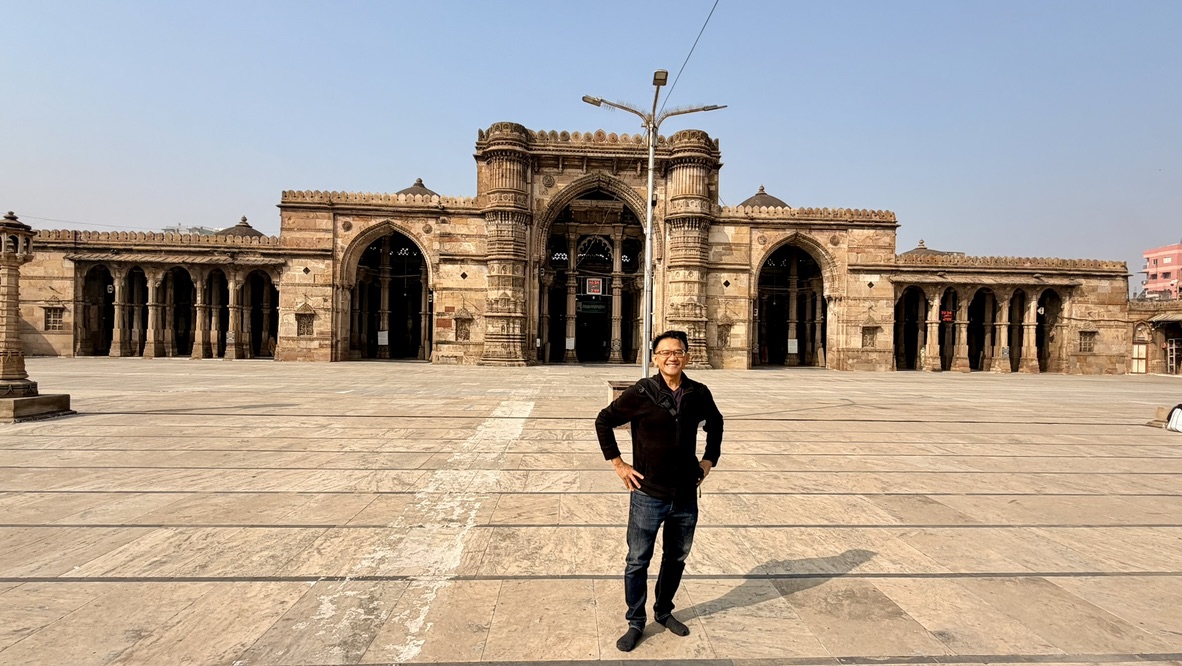 TOON standing in the broad stone courtyard before Jama Masjid in Ahmedabad
