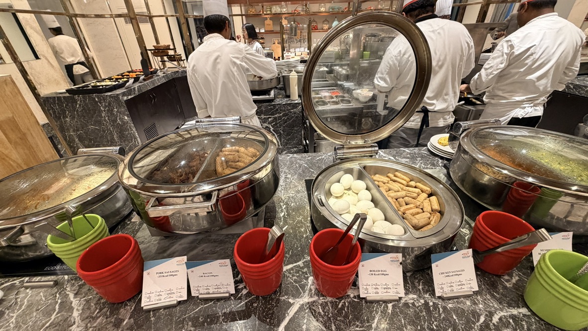Breakfast buffet with hot dishes and a staffed cooking station at ITC Narmada Ahmedabad
