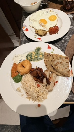 Breakfast plate with eggs, Indian dishes, breads, rice, mushrooms, and vegetables at ITC Narmada