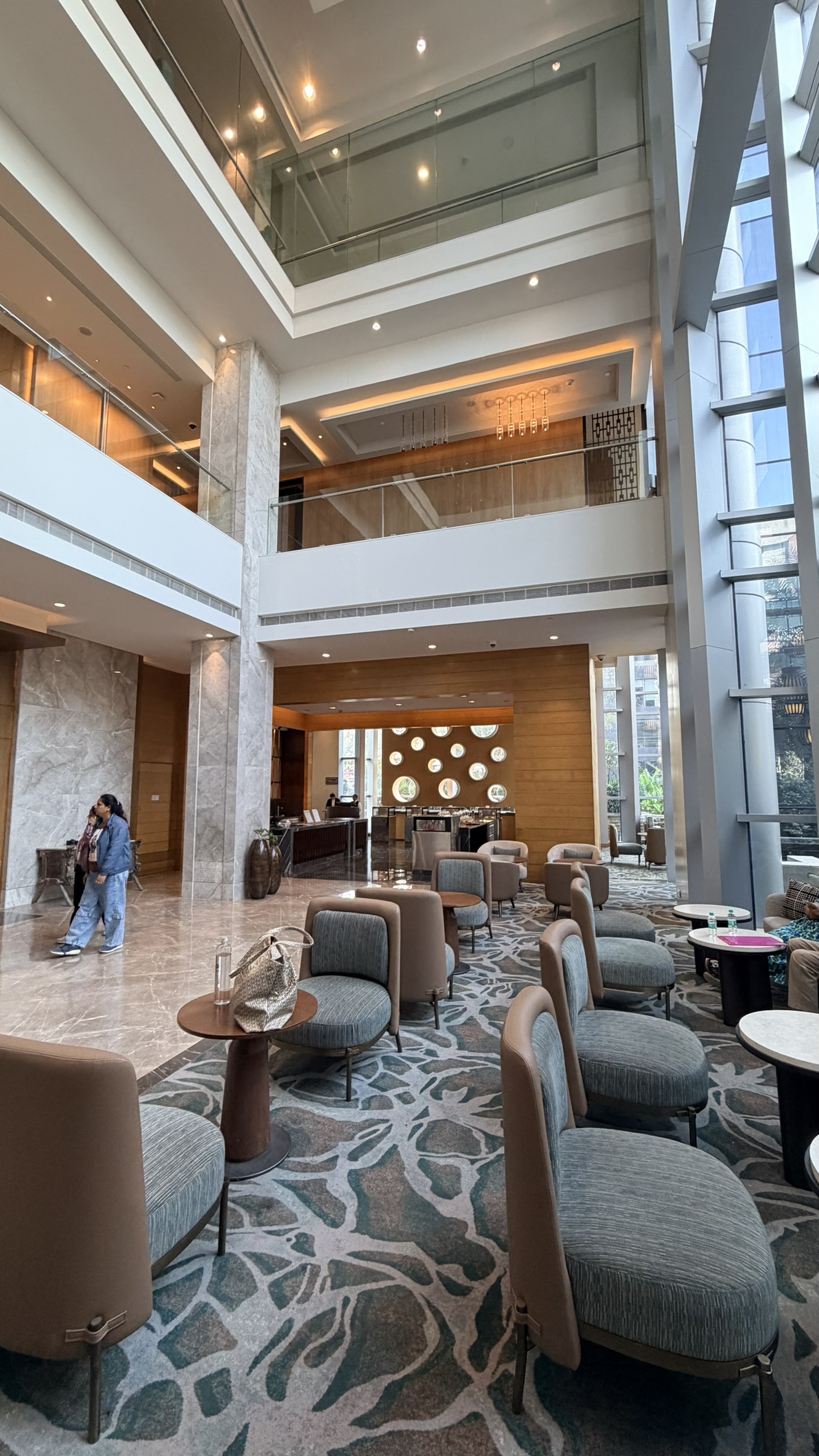 Tall light-filled lobby and seating area at Hyatt Regency Ahmedabad