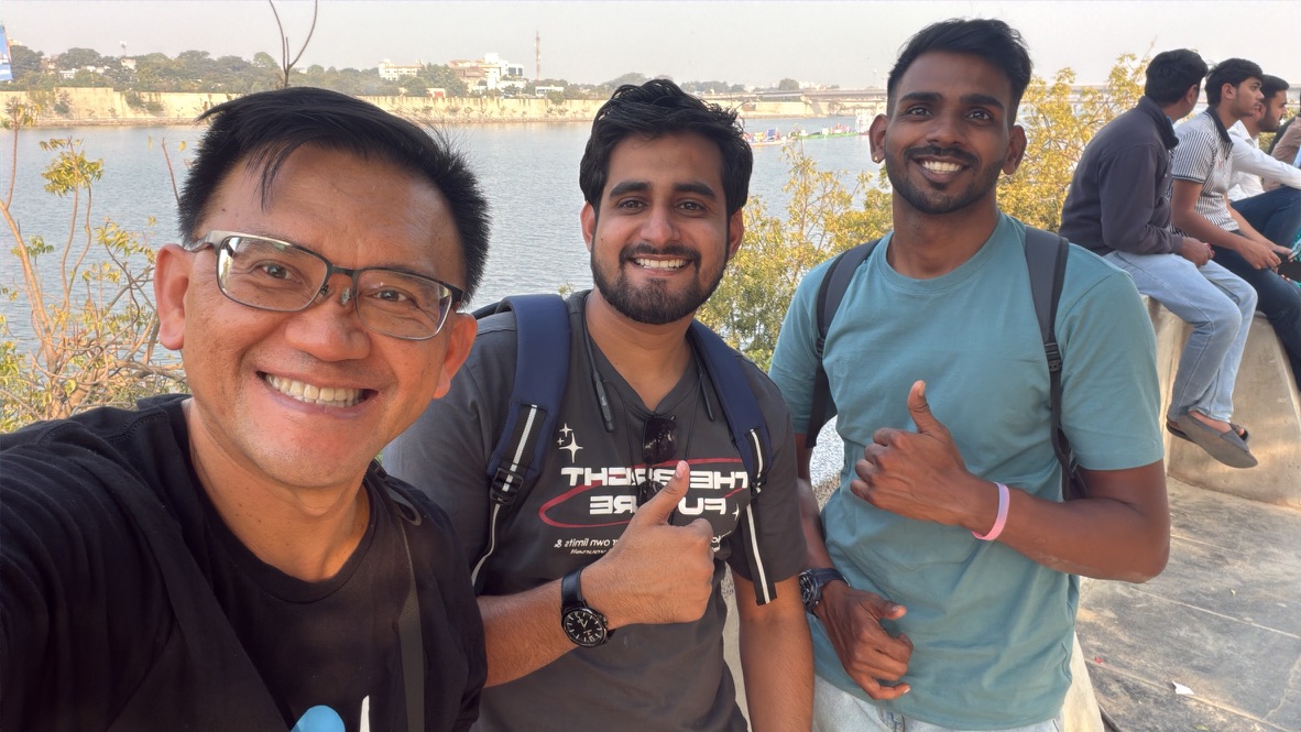TOON taking a friendly photograph with two festival visitors beside the Sabarmati River