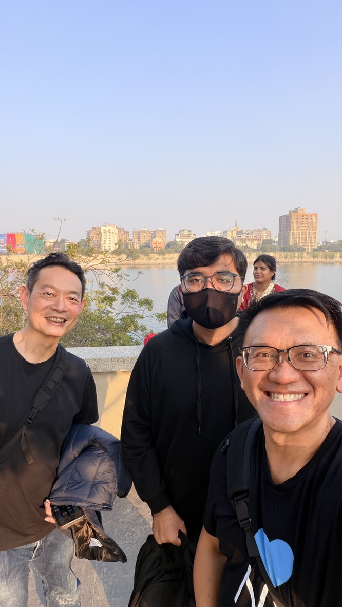 TOON and his travel companion taking a selfie with a new acquaintance beside the Sabarmati River