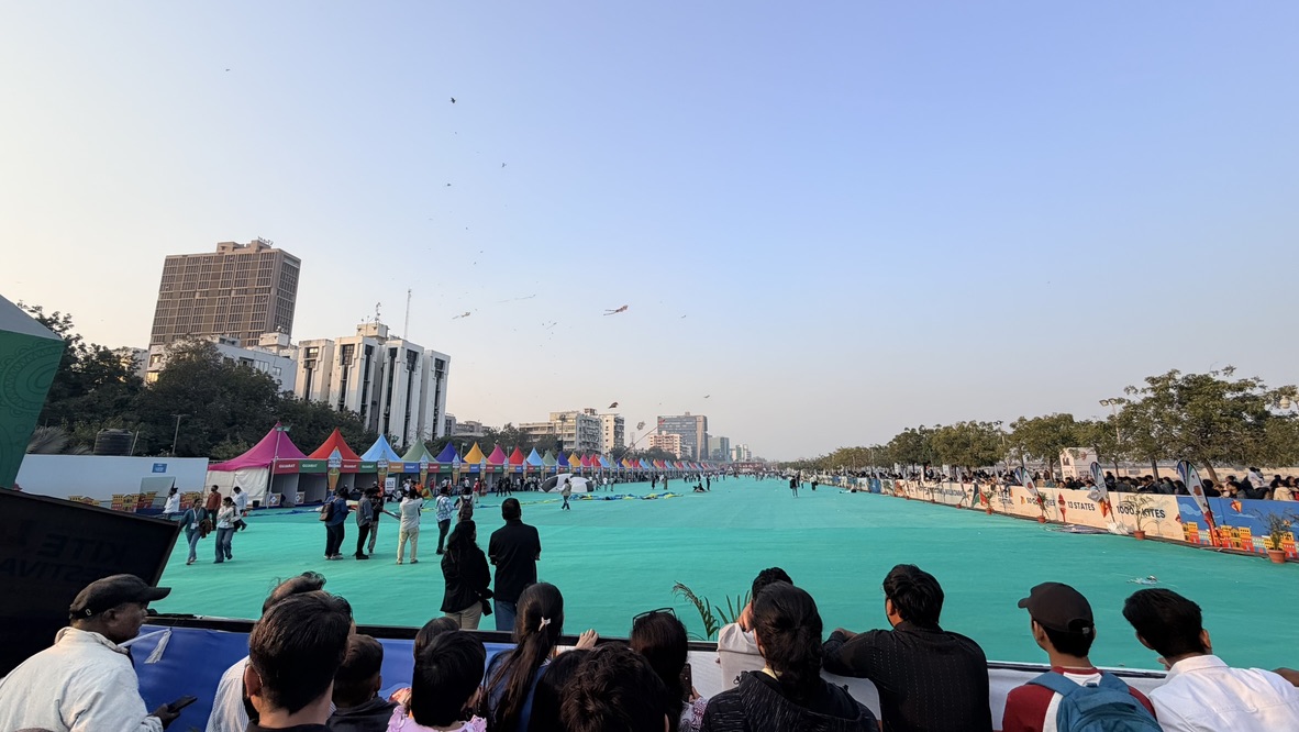 Wide view of the protected kite-flying arena and spectators at the International Kite Festival in Ahmedabad