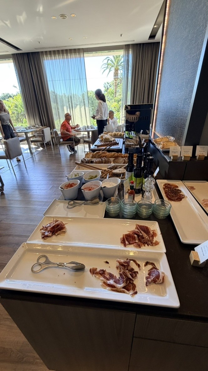 Jamón, breads, and condiments in the bright AC Hotel breakfast room
