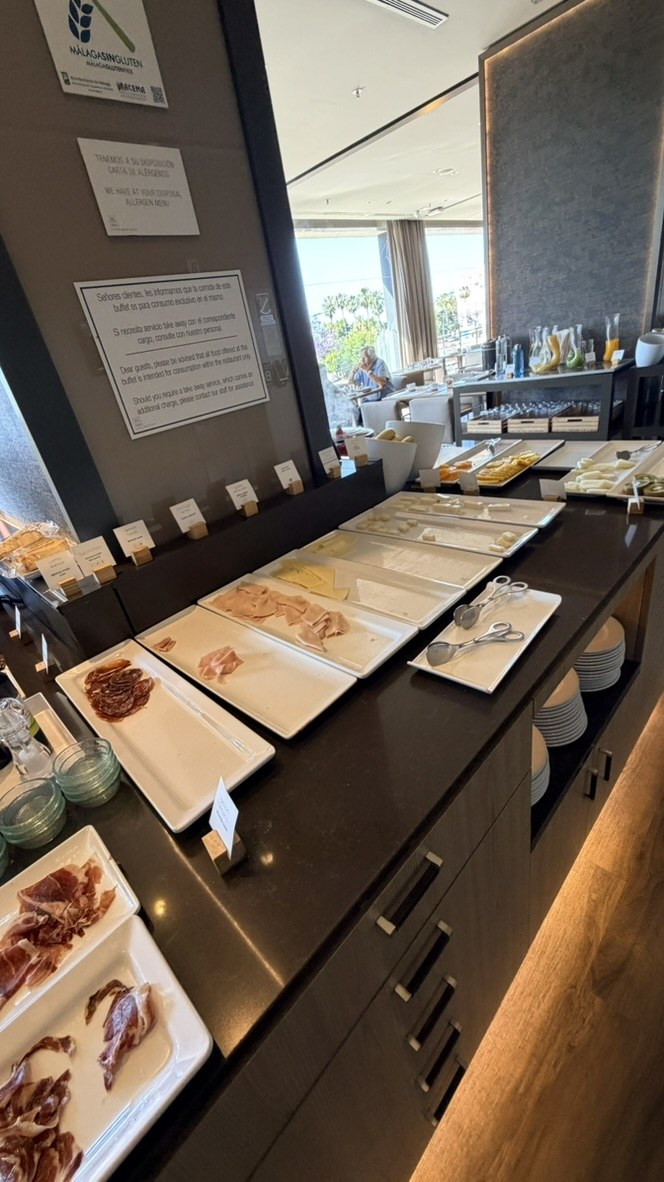 Cheese and Spanish cold cuts arranged across the breakfast buffet