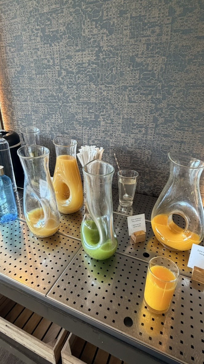 Carafes of orange and green juices at the breakfast buffet