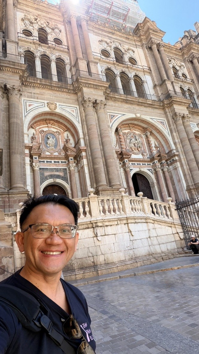 TOON smiling outside Málaga Cathedral after breakfast