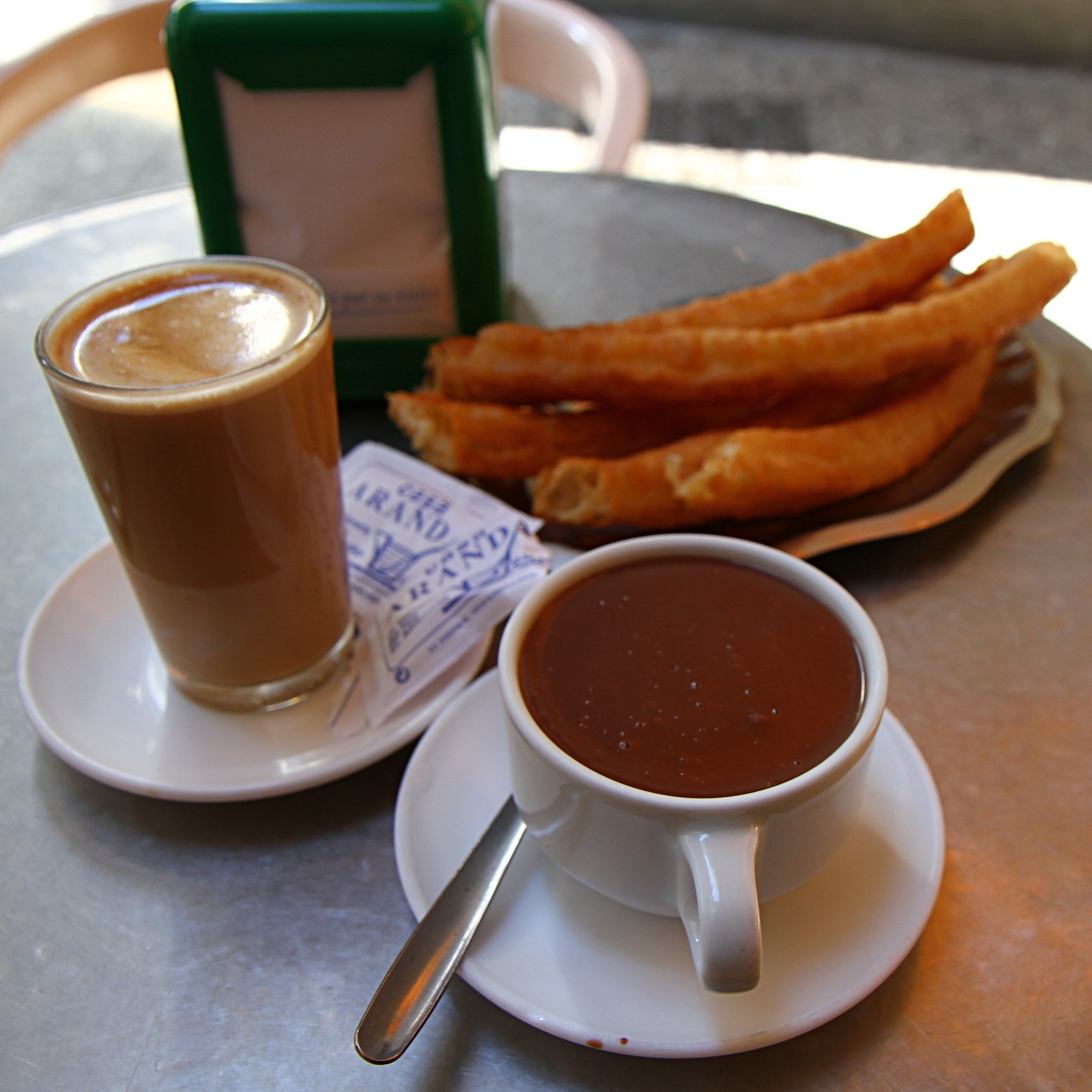 Café con leche, churros, and hot chocolate at Casa Aranda in Málaga