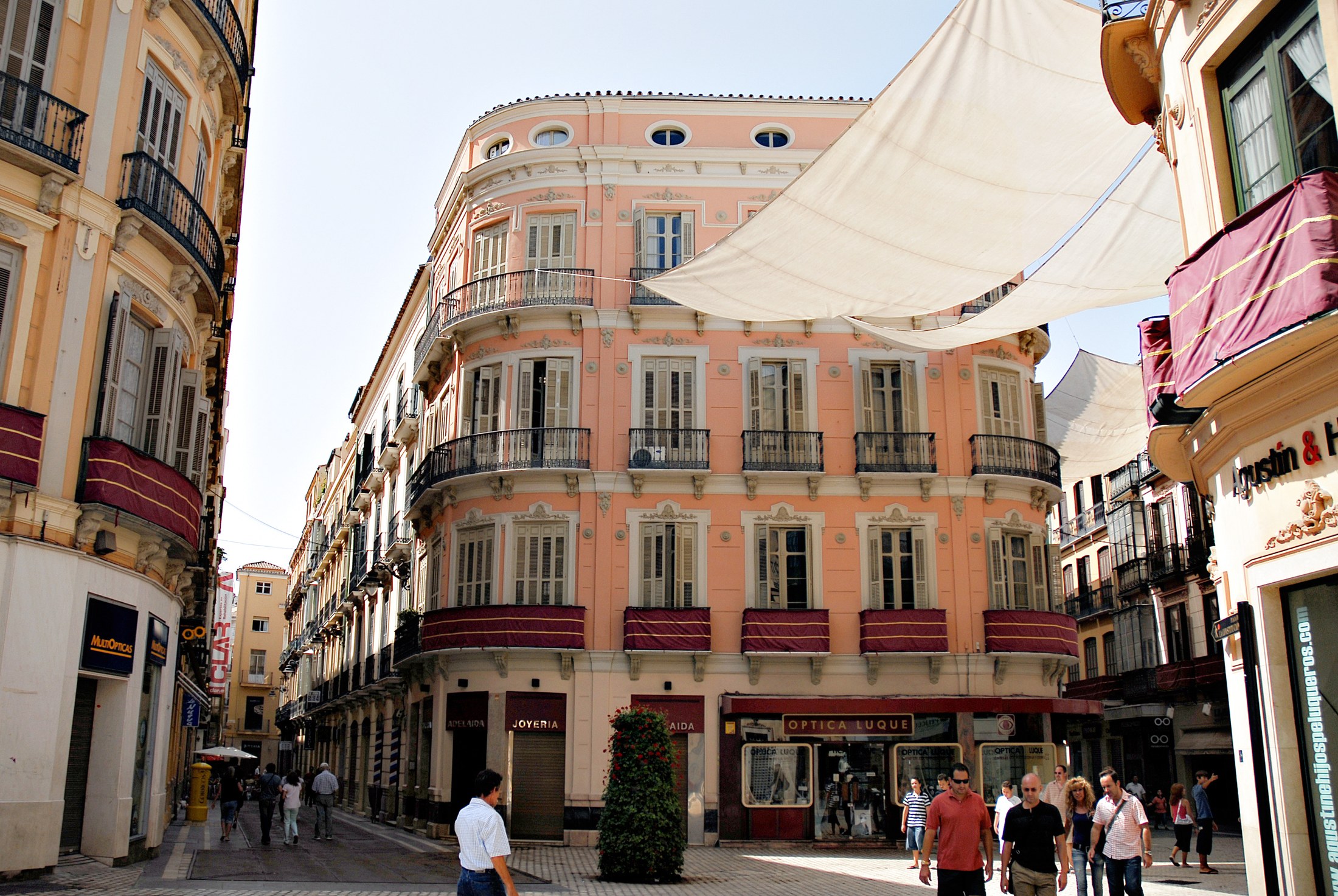 Historic façades and pedestrians along Calle Granada in Málaga