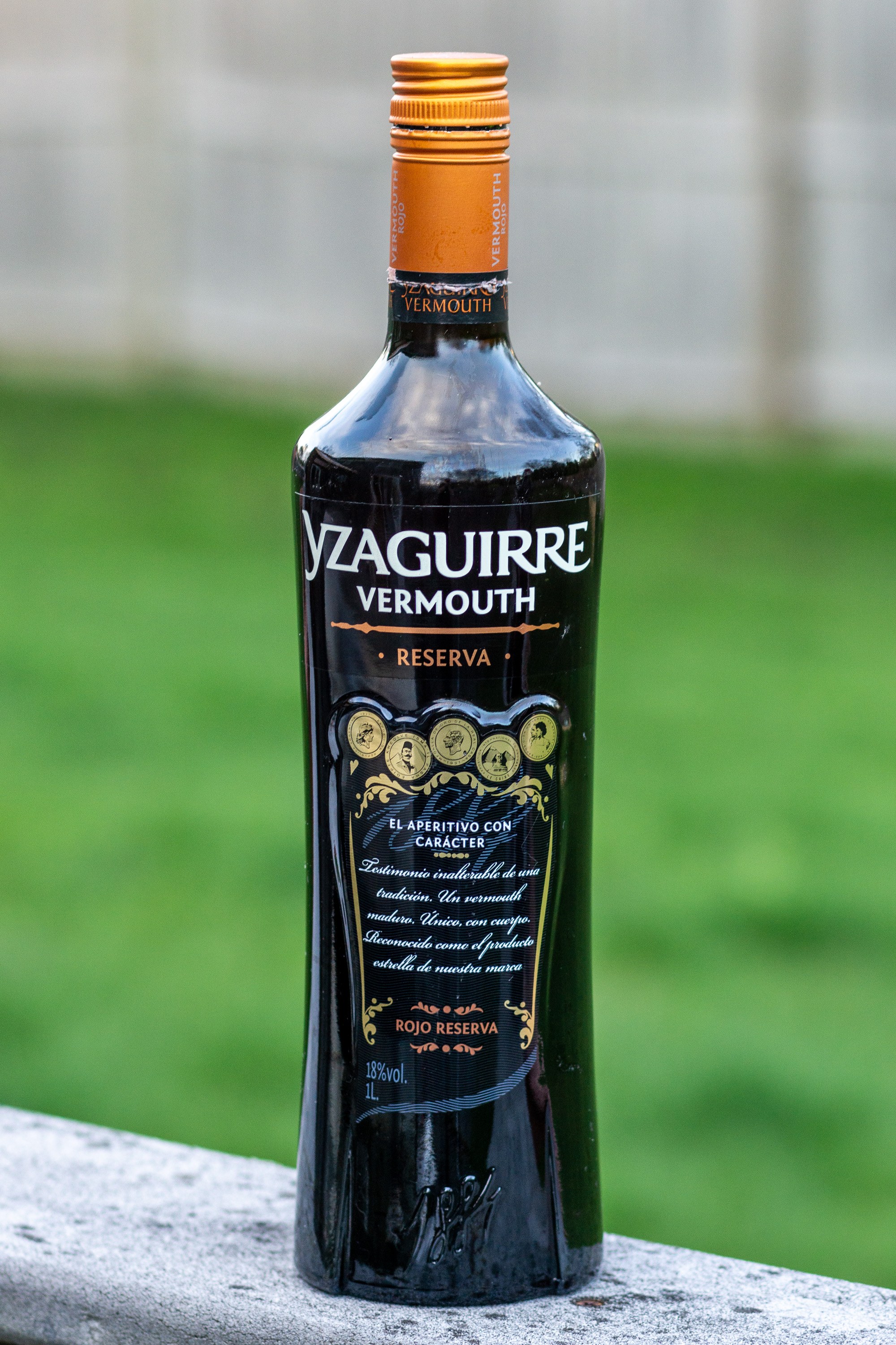 A bottle of Spanish vermouth photographed against a dark background