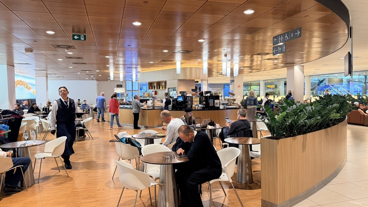 The warm wood interior and central café of KLM Crown Lounge 25 at Schiphol