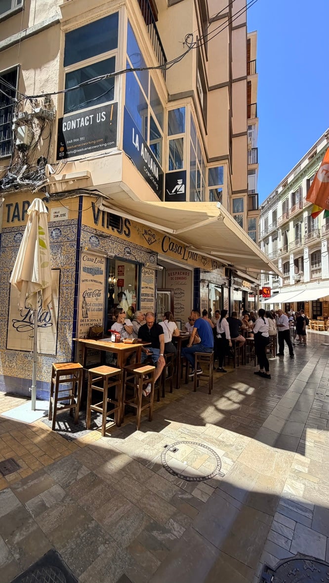 Casa Lola’s tiled corner and street terrace in Málaga