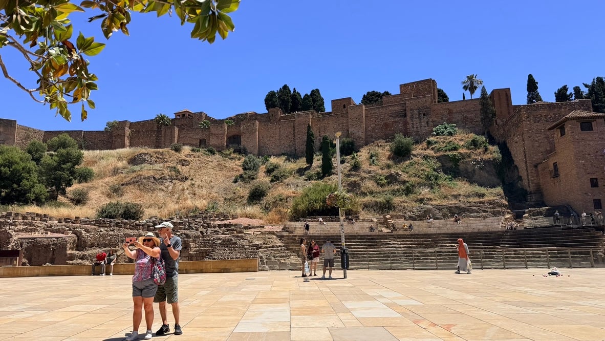 Málaga’s Roman Theatre with the Alcazaba walls rising behind it