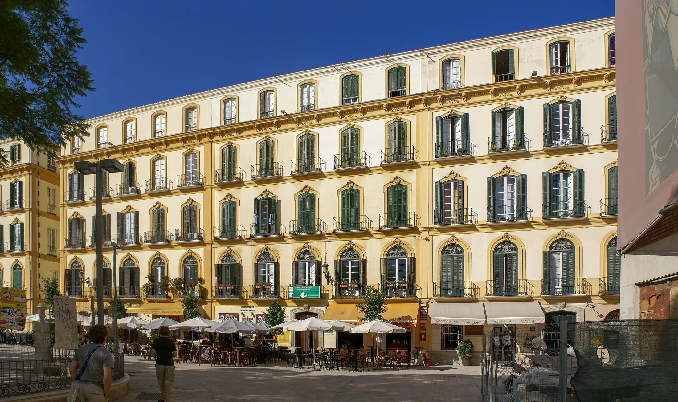 A wide daytime view across Plaza de la Merced in Málaga